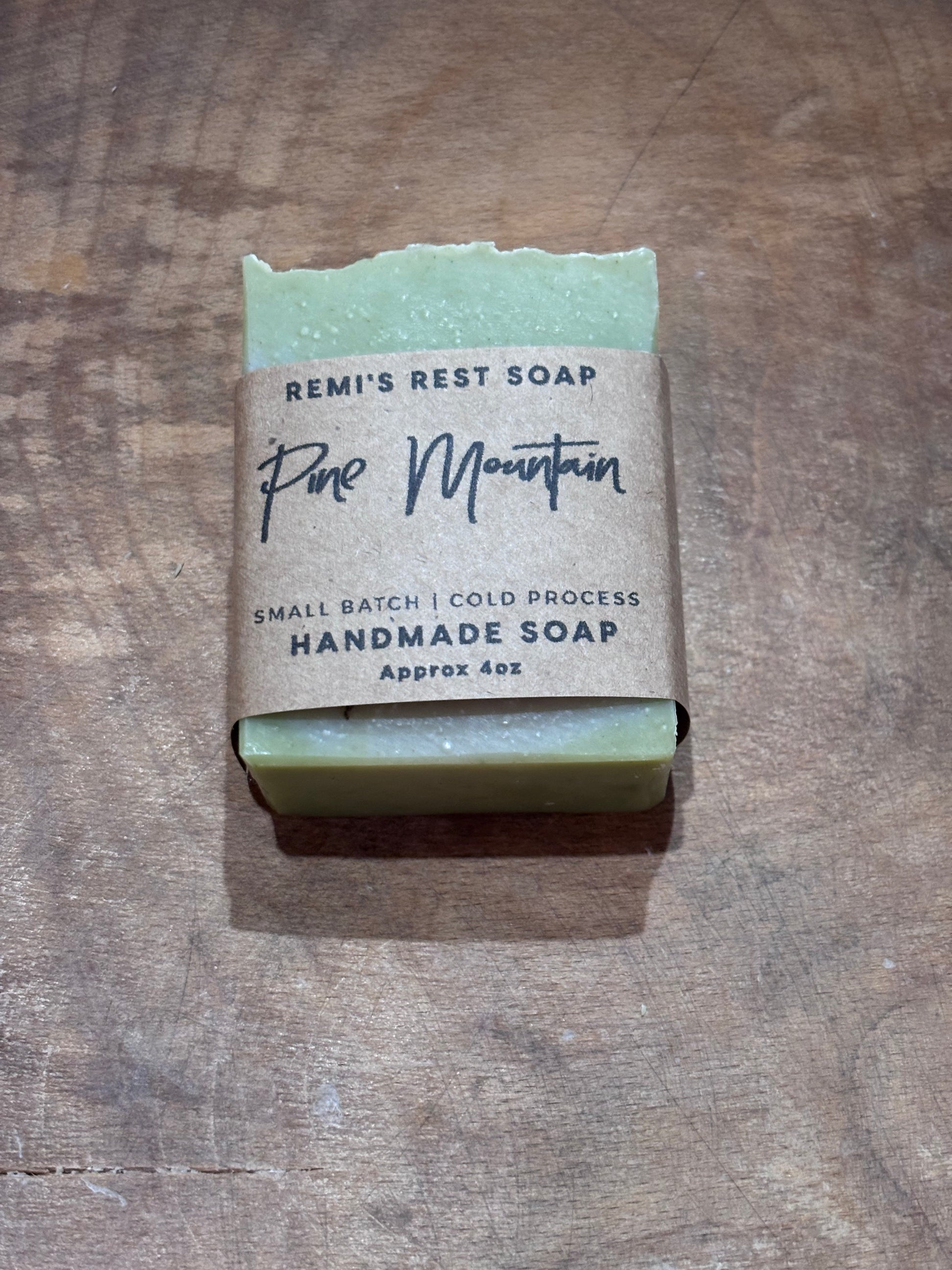 Green handmade soap in a wooden bowl. 
