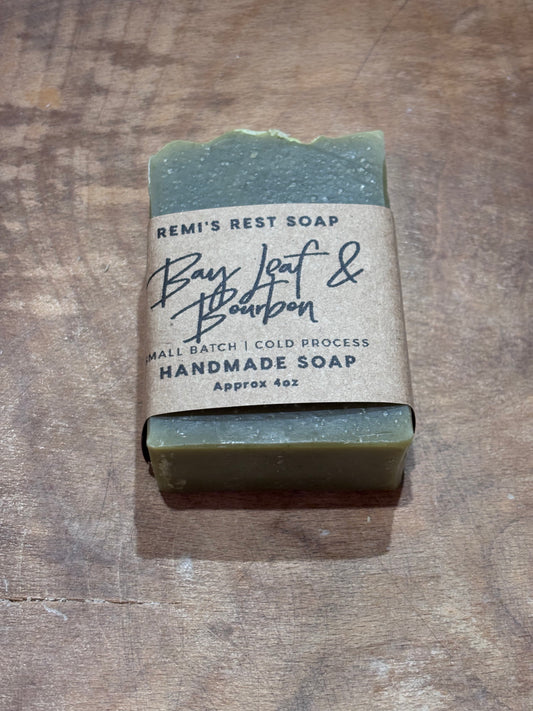 Bay Leaf & Bourbon. Dark green soap in a wooden bowl. 