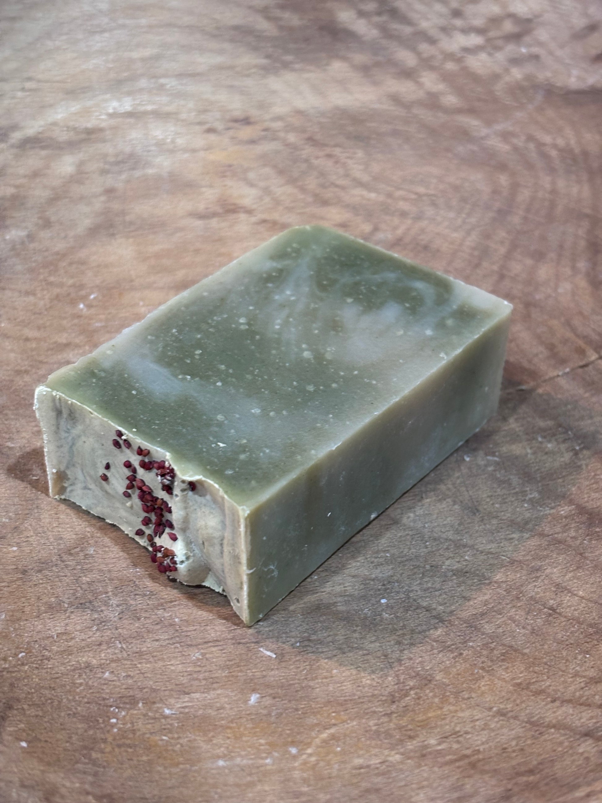 Lingonberry Spice soap. Green soap with red cranberry seeds on top for decoration. A clean scent that smells of high mountain pine and fresh air with hints of apple and musk.
Ingredients: water, olive oil, palm oil, coconut oil, castor oil, fragrance oil, spinach powder, cranberry seeds.
Because each bar is handmade and hand cut, exact colors and sizes may vary. Approx. weight is 4 oz.