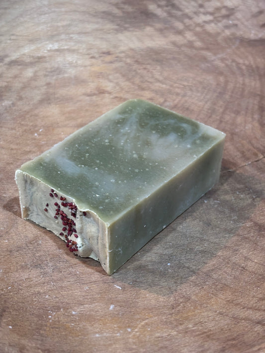 Lingonberry Spice soap. Green soap with red cranberry seeds on top for decoration. A clean scent that smells of high mountain pine and fresh air with hints of apple and musk.
Ingredients: water, olive oil, palm oil, coconut oil, castor oil, fragrance oil, spinach powder, cranberry seeds.
Because each bar is handmade and hand cut, exact colors and sizes may vary. Approx. weight is 4 oz.