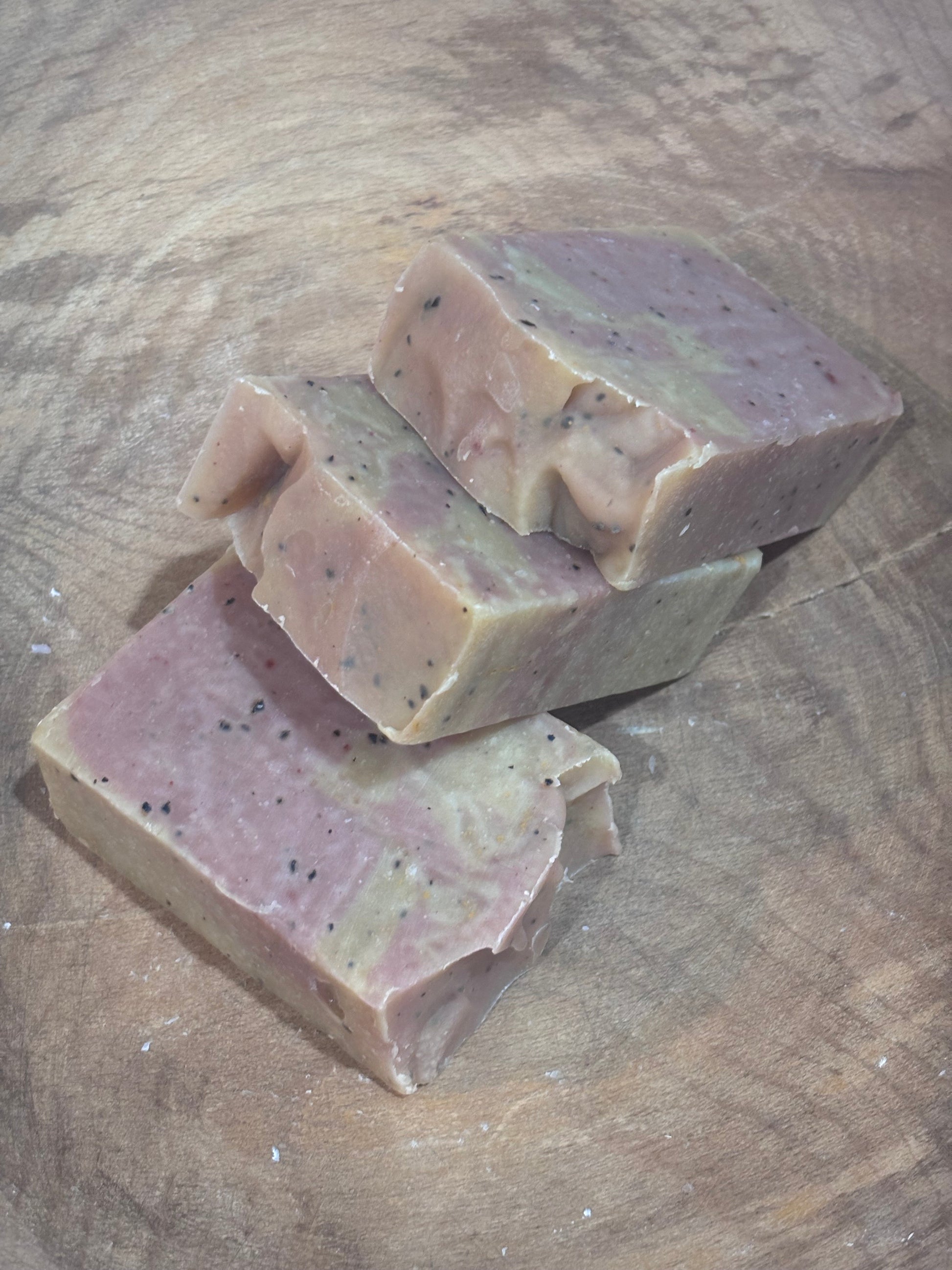 3 bars of pale yellow and pink soap on a wooden background.
Limited Edition! Rise N' Shine soap.
Scented with cinnamon, frankincense, orange, ginger and cedarwood essential oils. Colored with yellow brazilian clay and rose clay. Coffee grounds included. This has everything you need to wake you up! It will be fully cured just in time for Daylights Savings, on March 8th.
Ingredients include saponified oils of olive, palm, coconut, and castor; essential oil blend; ground coffee